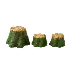 three pieces of grass that have been cut into small trees and are sitting on top of each other