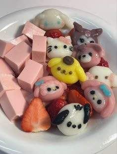 a white plate topped with lots of different types of candys and marshmallows