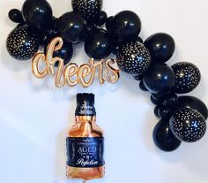 a bottle of beer and balloons are on the wall for an event or party decoration