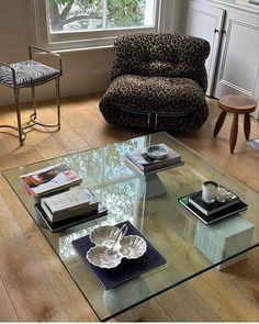 a living room with a couch, chair and coffee table in it's center