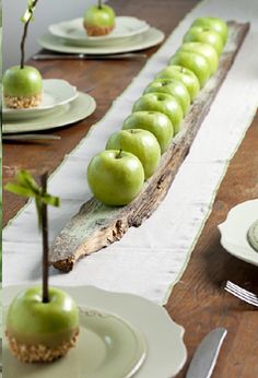 there are green apples on the table ready to be eaten and served with silverware