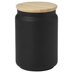 a black canister with a wooden lid