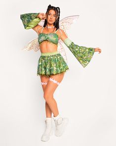 a woman in a green and white costume is posing for the camera with her hands on her hips