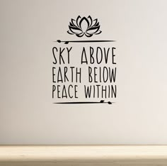 a wall decal with the words sky above earth below peace within it, and a lotus