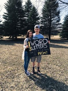 a man and woman holding up a sign that says word letters from prom to prom