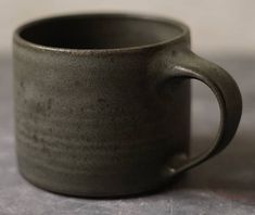 a black cup sitting on top of a table