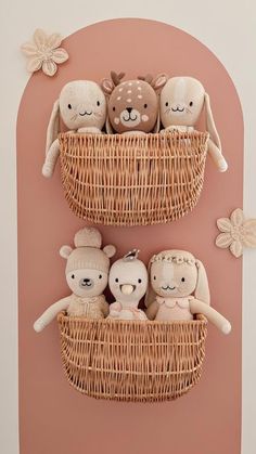 three stuffed animals are in a basket on the wall, one is holding a teddy bear