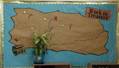 a bulletin board with a map on it and some bookshelves in front of it