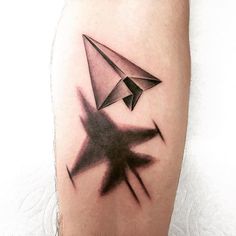 a black and white photo of an origami tattoo