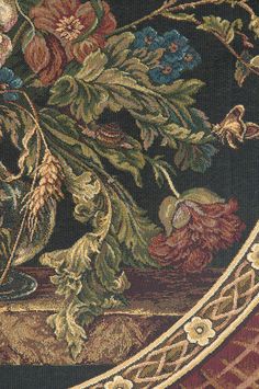 an ornate tapestry with flowers and vines on the border is shown in this close up photo