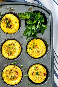 an overhead view of several muffins in a pan with parsley on the side