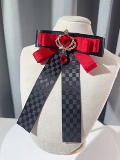 Add a touch of regal charm to your outfit with our rhinestoned crown bow tie/brooch. Available in both black and red, this versatile accessory features a dazzling rhinestone-encrusted crown design that exudes elegance and sophistication. Wear it as a bow tie or use it as a brooch to elevate your look with a hint of royal allure. Perfect for adding a touch of glamour to any outfit, this one-of-a-kind piece is sure to turn heads and make a statement. Whether you're dressing up for a special occasi Black Bow Tie Jewelry For Party, Black Bow Tie Jewelry For Formal Occasions, Black Jewelry With Decorative Bow For Party, Formal Red Rhinestone Brooch, Formal Red Rhinestones Brooches, Black Brooch With Decorative Bow For Evening, Elegant Red Pins For Party, Elegant Red Party Pins, Black Rhinestones Brooch For Gift