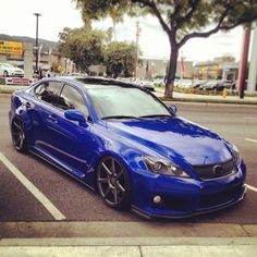 a blue car is parked in a parking lot