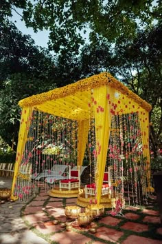 a gazebo decorated with yellow and red flowers