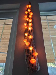 a long light fixture with many lights on it's side hanging from the wall