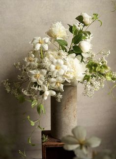 a vase filled with white flowers on top of a table