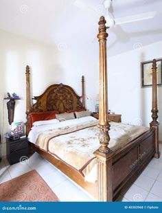 a large bed sitting in the middle of a bedroom