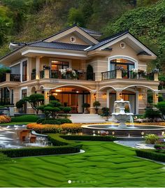 a large house with lots of greenery in the front yard and landscaping around it