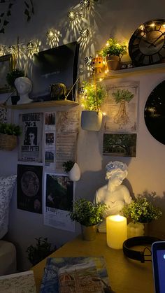 a living room filled with lots of plants and lights on the wall next to a laptop computer