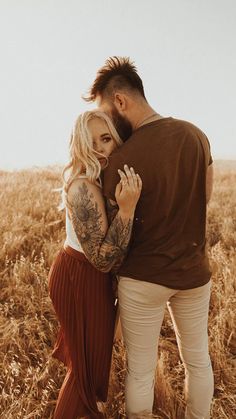 a man and woman embracing in a field