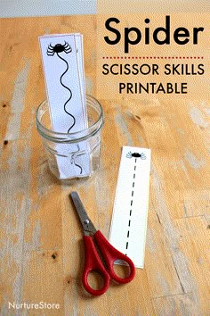 scissors are sitting on the table next to a printable spider