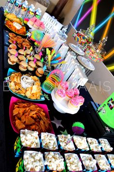 a table filled with lots of different types of snacks and desserts on it's sides