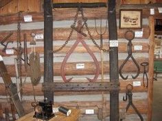 there are many old tools hanging on the wall