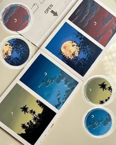 four stickers with different images of trees and the moon in them are on top of a table