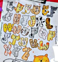 a drawing of cats and other animals on a piece of paper with writing underneath it