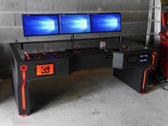 a desk that has two monitors on it