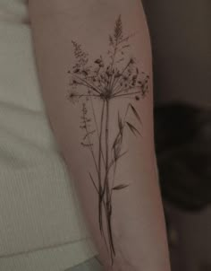 a woman's arm with a flower tattoo on it