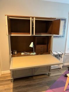 a room with a desk, chair and shelves on the wall next to each other