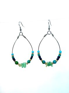 Enhance your style with our handcrafted large teardrop hoop earrings, featuring beautiful green aventurine chips and Australian jasper, accented with vibrant seed beads. These stunning earrings combine natural beauty with unique textures, making them a perfect statement piece for any outfit. Green aventurine is known as the "stone of opportunity," believed to attract luck and prosperity. Its calming energy promotes emotional healing and balance, encouraging a sense of confidence and well-being. This stone is also associated with growth and renewal, making it an ideal companion for new beginnings. Australian jasper, with its rich earthy tones, is revered for its grounding properties. It is thought to enhance creativity and foster a deep connection to the earth, providing stability and stren Green Beaded Teardrop Earrings, Green Teardrop Hoop Earrings, Seed Bead Hoop Earrings, Green Beaded Dangle Hoop Earrings, Green Aventurine Drop Earrings, Green Wire-wrapped Dangle Hoop Earrings, Beaded Hoop Earrings, Beaded Hoops, Stunning Earrings