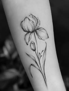 a black and white photo of a flower on the arm