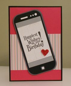 a cell phone sitting on top of a card with a happy birthday message on it