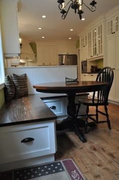 a kitchen with a table and chairs in it