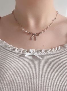 Featuring a dainty silver chain accented with a graceful bow design and lustrous pearls, this necklace exudes timeless elegance and femininity. Perfect for those who embrace the soft, romantic coquette aesthetic, this necklace is versatile enough to complement casual outfits or add a touch of charm to formal ensembles. Why You'll Love It: Coquette Aesthetic: A perfect match for feminine, vintage-inspired styles. High-Quality Craftsmanship: Designed with a durable silver-tone chain and lustrous faux pearls for an elegant finish. Stylish and Versatile: Ideal for daily wear, special occasions, or layering with other jewelry. Thoughtful Gift Idea: A meaningful gift for birthdays, anniversaries, Valentine's Day, or any celebration. Details: Material: Silver-tone metal and faux pearls. Length: S Ingenue Jewelry, It Girl Era, Romantic Coquette, Band Design, Jewelry Aesthetic, Ribbon Design, Coquette Bow, Girl Things, Bow Design