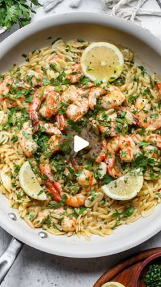 a bowl filled with pasta and shrimp on top of a table