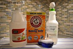 two bottles of baking soda and a toothbrush on a counter