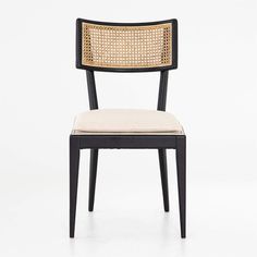 a black and white chair with a beige cushion on top of it's back