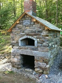 an outdoor brick oven in the woods