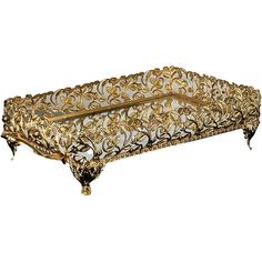 an ornately decorated tray is shown with gold trimmings and metal accents on the edges