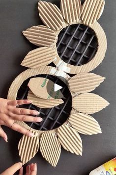 someone is making a sunflower out of cardboard and other things to make it look like they are holding something in their hands