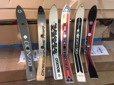 some skis are lined up in a row and ready to be shipped into the store