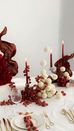 the table is set with red and white decorations