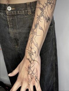 a woman's arm with tattoos on it