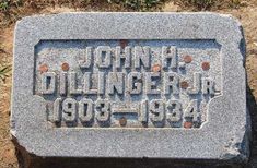 a headstone with the name john dilngern in black and orange letters on it