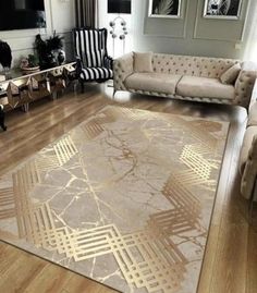 a living room with couches, chairs and a rug on the floor in front of a tv