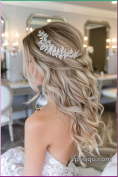 a woman wearing a wedding hair comb with flowers on it's head, in front of a mirror