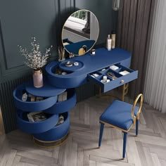 a blue vanity table with a mirror and stool in front of it on a wooden floor